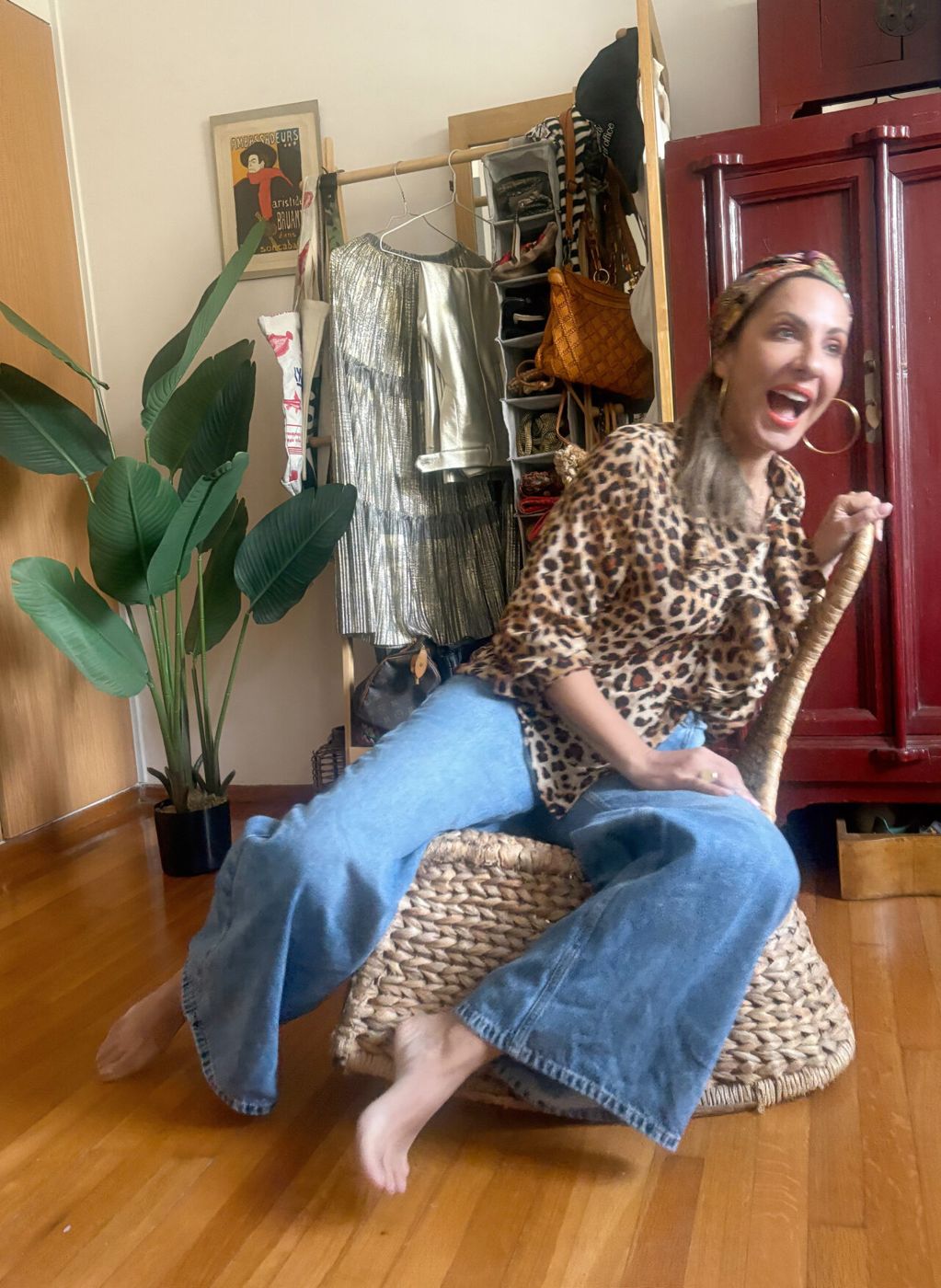 Sophia sitting smiling on a chair, in jeans